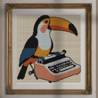 toucan-typing-on-typewrit alternative framed cross stitch mockup, realistic finished embroidery presentation