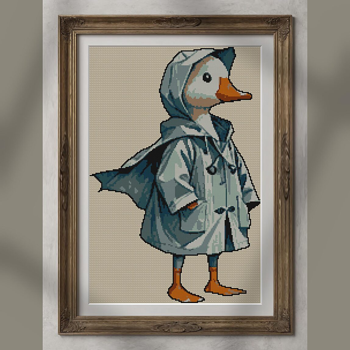 goose-with-raincoat-and-b alternative framed cross stitch mockup, realistic finished embroidery presentation