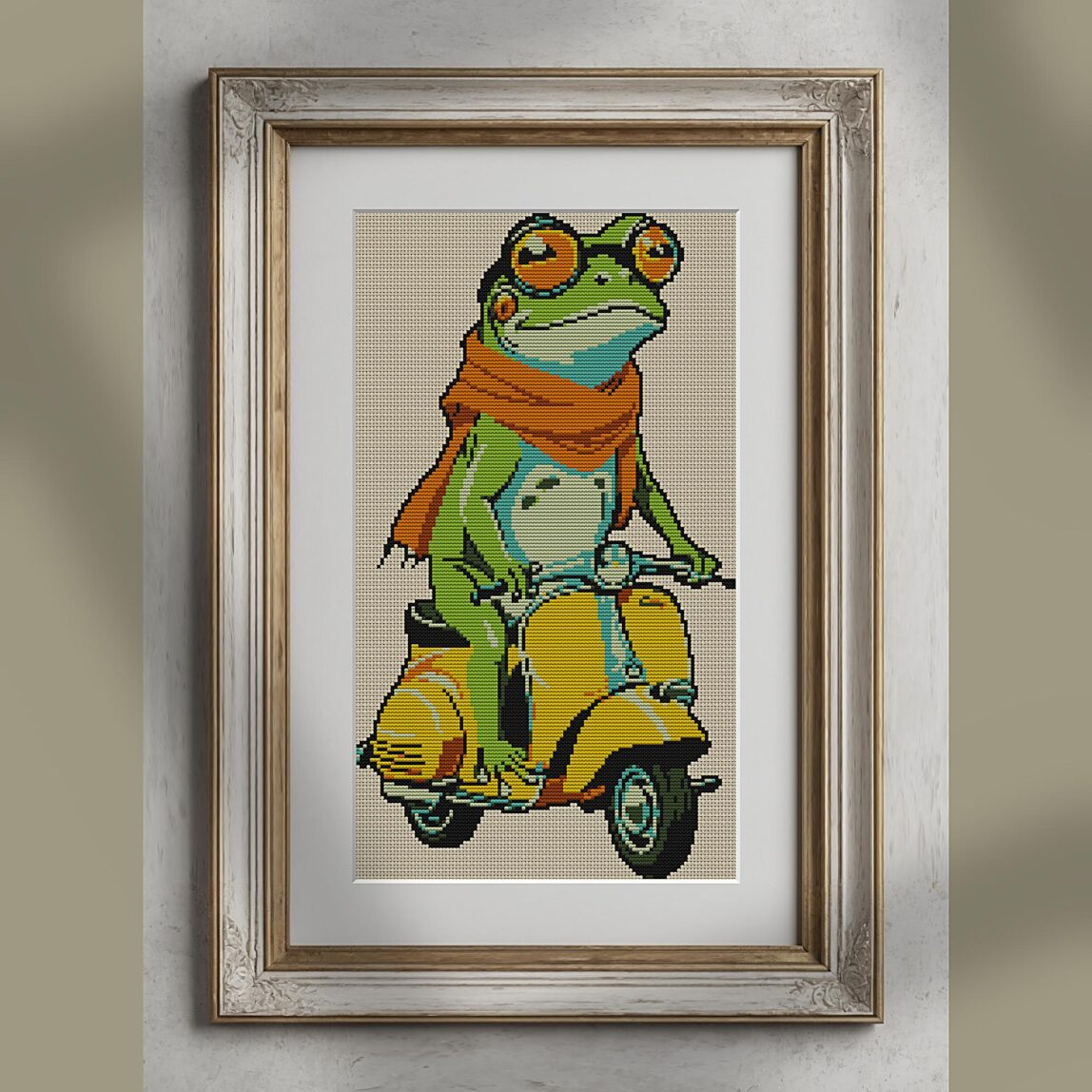 frog-on-vespa alternative framed cross stitch mockup, realistic finished embroidery presentation